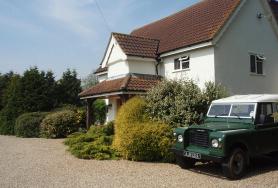 Front of house and old Land Rover